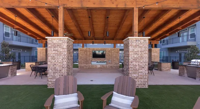 a view of a building with a garden and sitting area