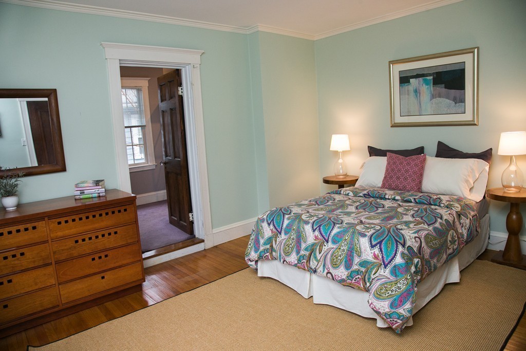 239 Clark Road Brookline, MA 02445 - Photo 8 of 9 a bedroom with a bed and a dresser in it