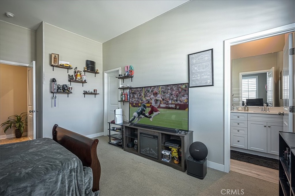 13471 Planet Court Riverside, CA 92503 - Photo 11 of 51 a bedroom with a bed and a flat tv screen