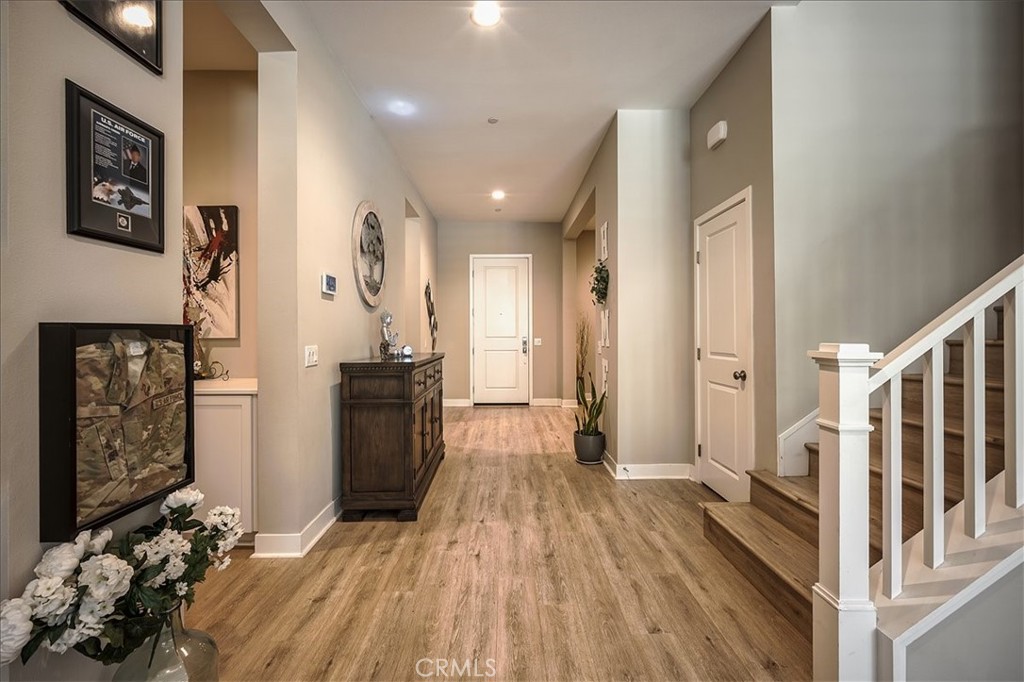 13471 Planet Court Riverside, CA 92503 - Photo 13 of 51 a view of a hallway with wooden floor and staircase