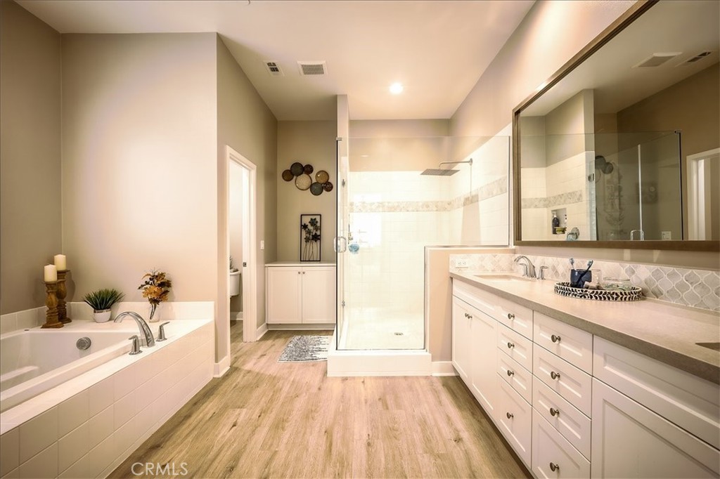 13471 Planet Court Riverside, CA 92503 - Photo 19 of 51 a spacious bathroom with a double vanity sink a mirror and a bathtub