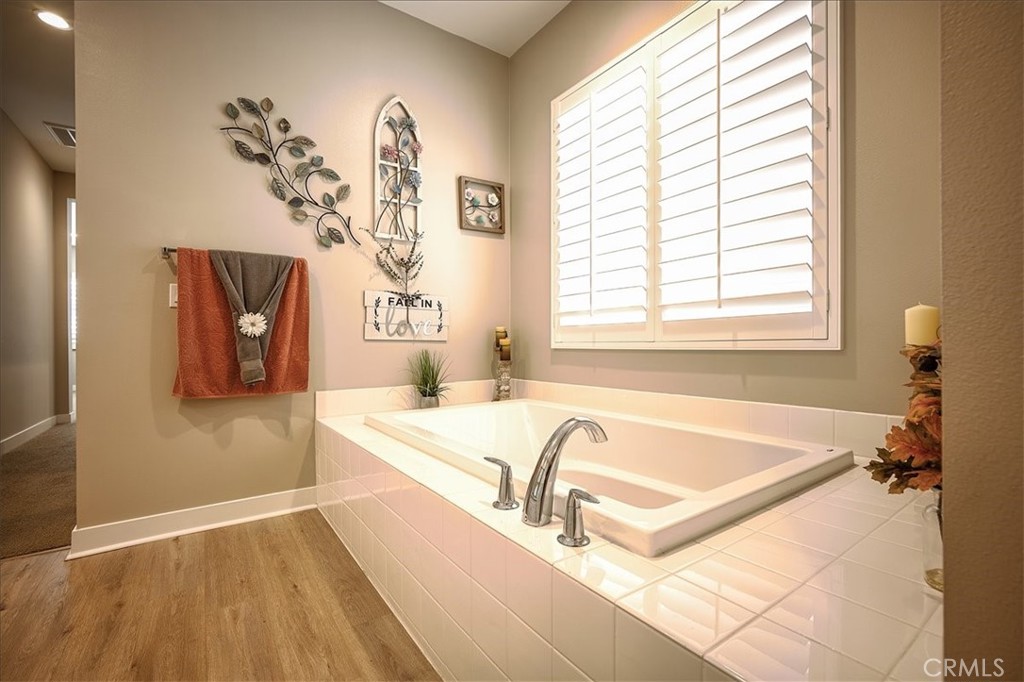 13471 Planet Court Riverside, CA 92503 - Photo 21 of 51 a bathroom with a tub a sink and a window