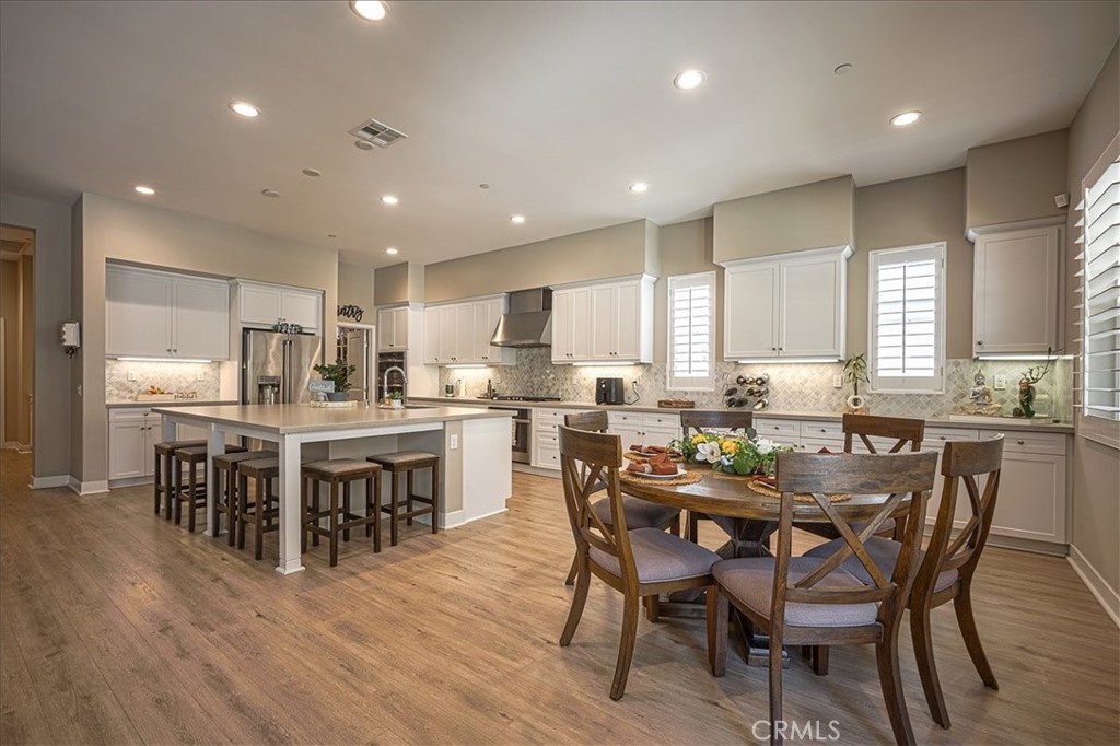 13471 Planet Court Riverside, CA 92503 - Photo 25 of 51 a view of a dining room with furniture wooden floor and kitchen view