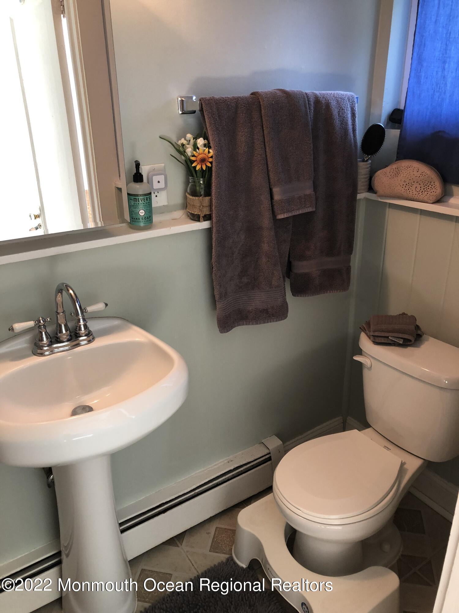 1737 Belmar Boulevard, Unit A Belmar, NJ 07719 - Photo 13 of 15 a bathroom with a toilet and a sink