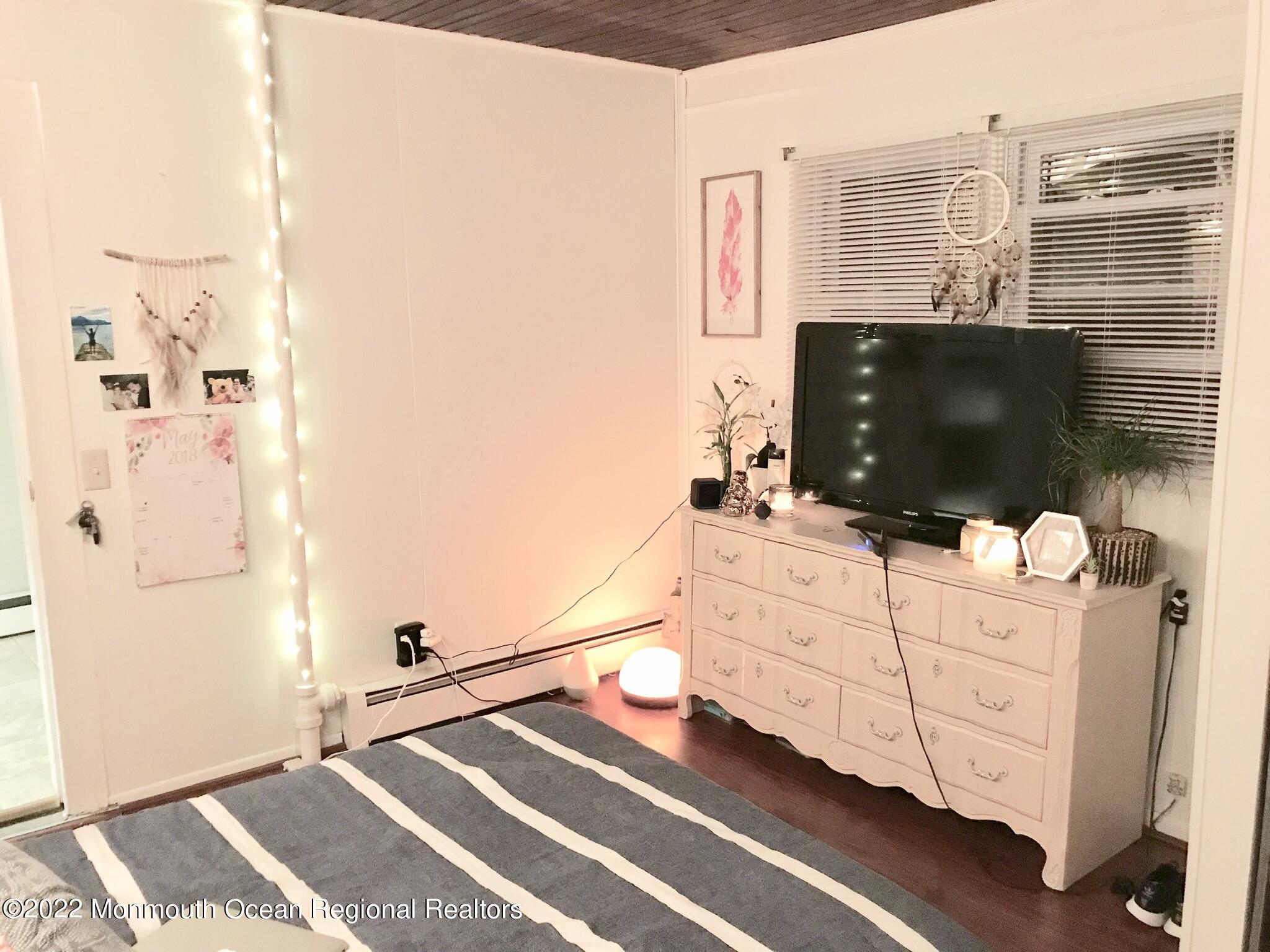 1737 Belmar Boulevard, Unit A Belmar, NJ 07719 - Photo 14 of 15 a living room with furniture and a flat screen tv