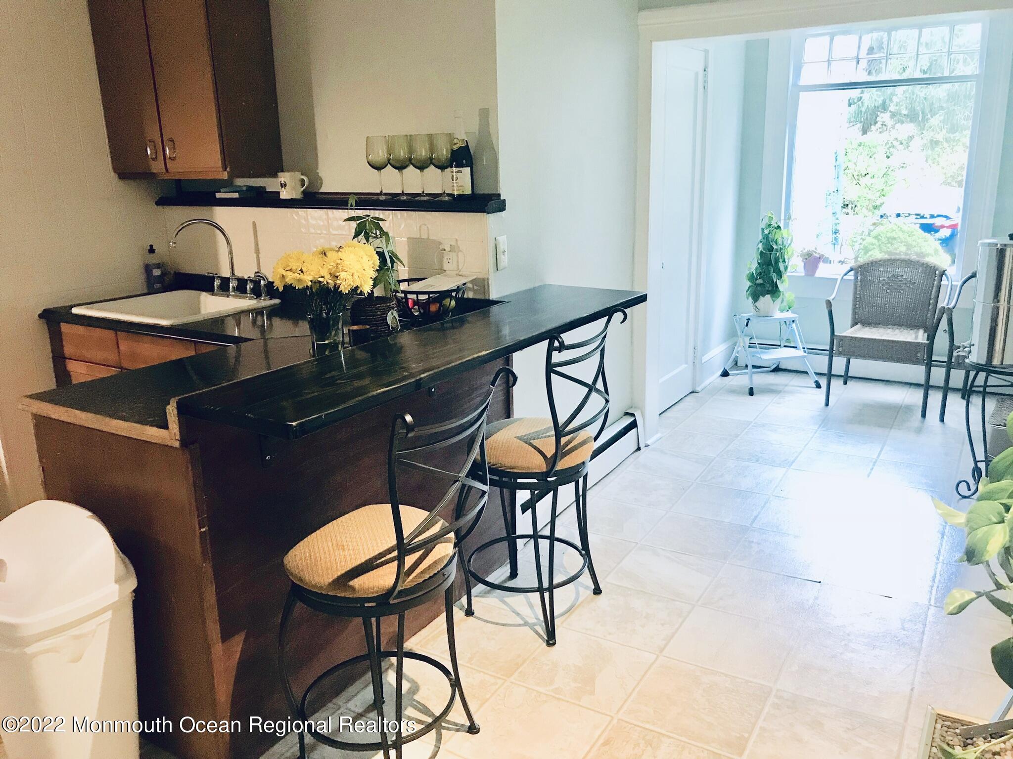 1737 Belmar Boulevard, Unit A Belmar, NJ 07719 - Photo 9 of 15 a reading room with furniture a rug and a window