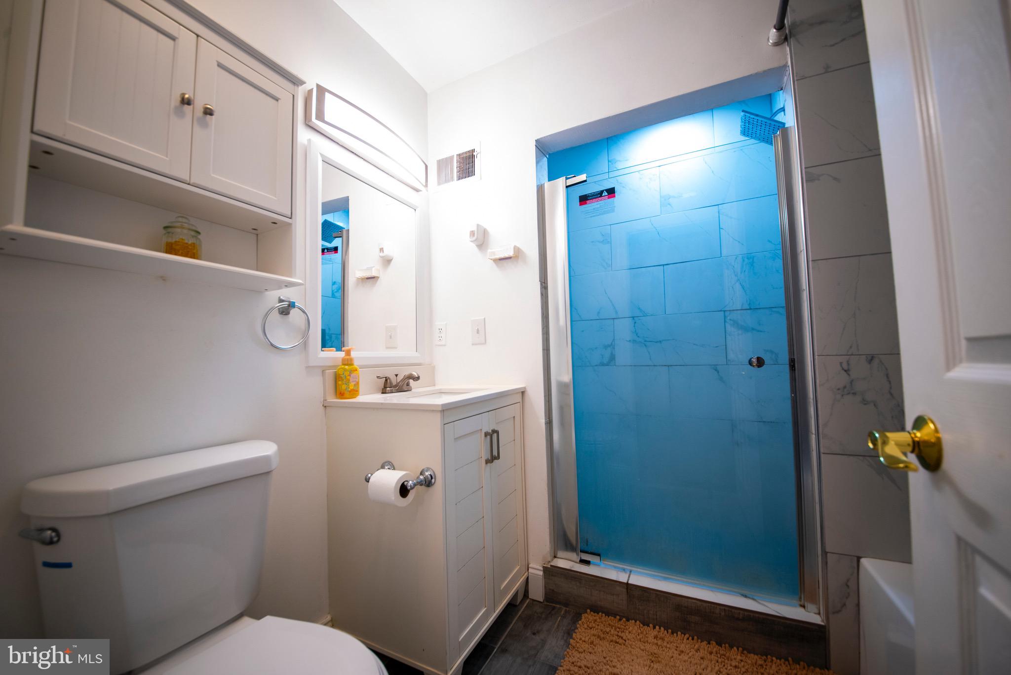 9355 Pan Ridge Road, Unit 9355 Parkville, MD 21234 - Photo 20 of 32 a bathroom with a sink a toilet and shower