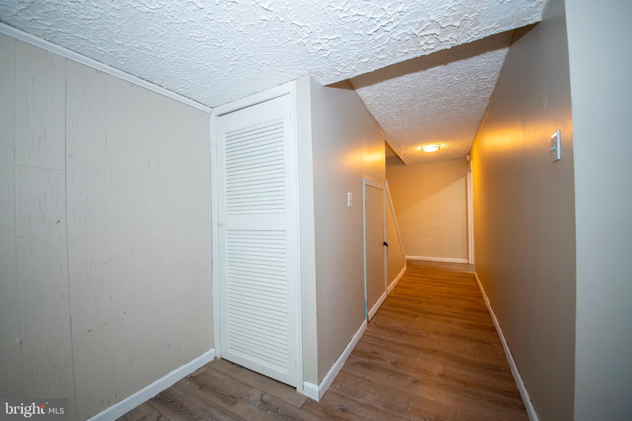 9355 Pan Ridge Road, Unit 9355 Parkville, MD 21234 - Photo 25 of 32 a view of a hallway with wooden floor