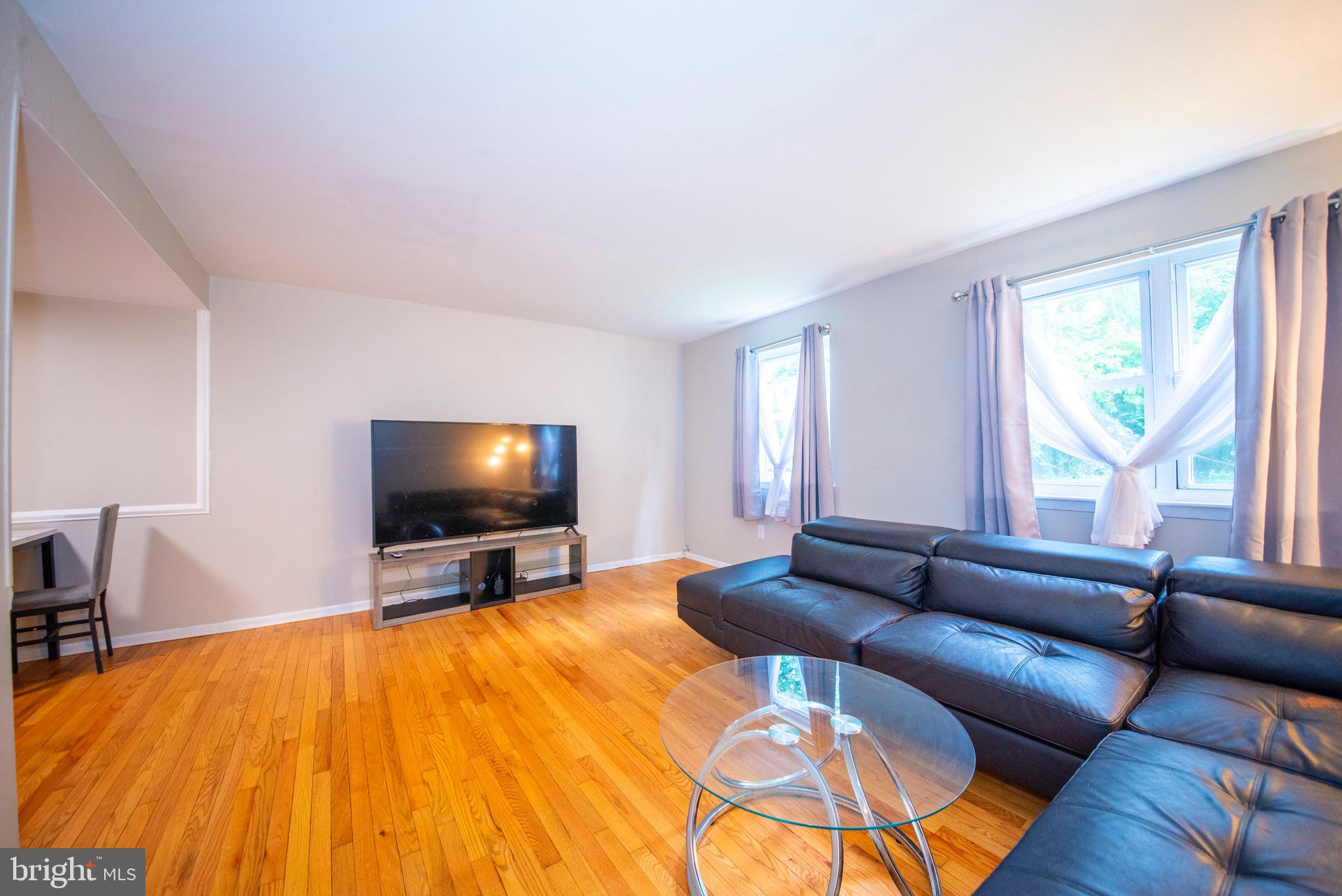 9355 Pan Ridge Road, Unit 9355 Parkville, MD 21234 - Photo 9 of 32 a living room with furniture and a flat screen tv