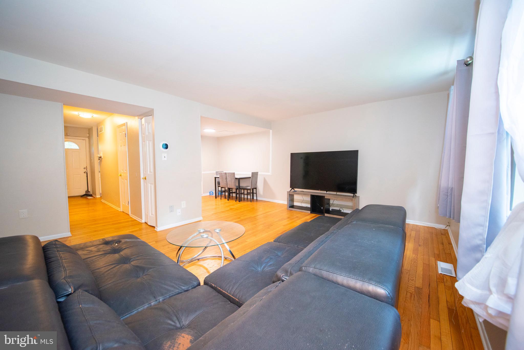 9355 Pan Ridge Road, Unit 9355 Parkville, MD 21234 - Photo 10 of 32 a living room with furniture and a flat screen tv