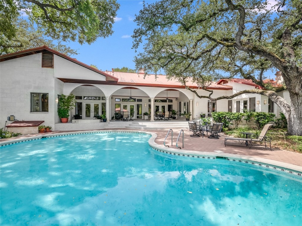 a front view of a house with garden and sitting area