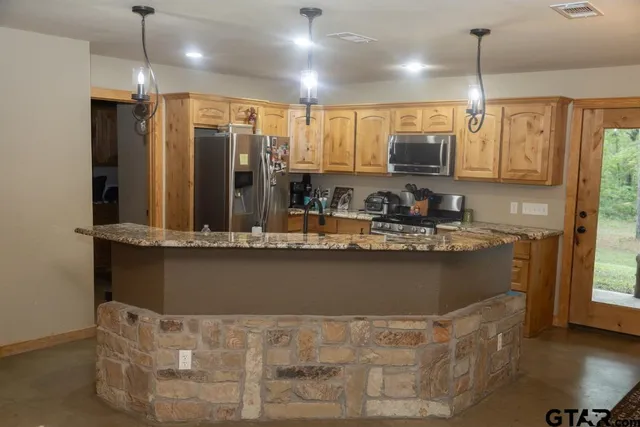 a kitchen with counter top space and stainless steel appliances