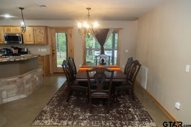 a view of a dining room with furniture window and outside view