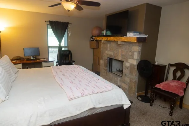 a bedroom with a bed and a fireplace