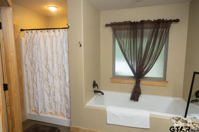 a bathroom with a sink a mirror and a shower