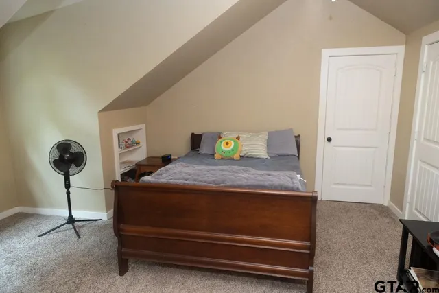 a bedroom with a bed and a table in it