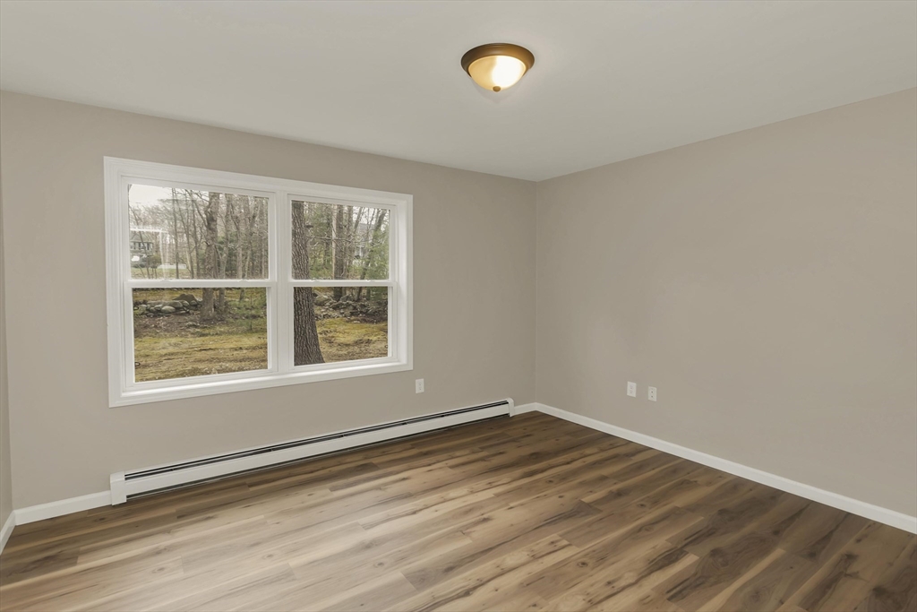 374 Rondeau Street Palmer, MA 01069 - Photo 12 of 27 an empty room with wooden floor and windows