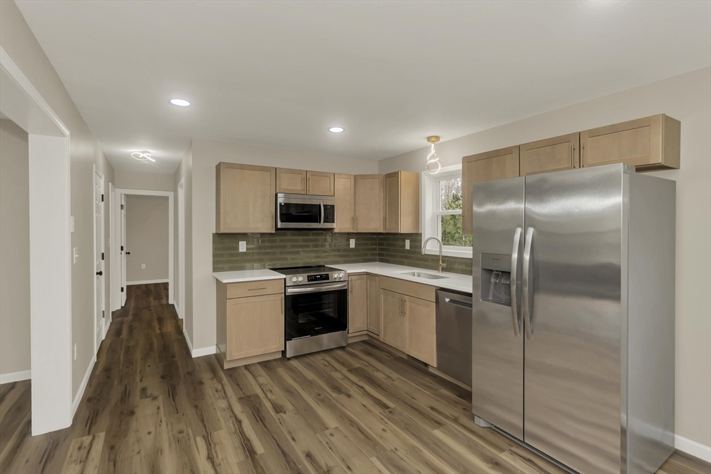 374 Rondeau Street Palmer, MA 01069 - Photo 2 of 27 a kitchen with stainless steel appliances granite countertop a refrigerator a stove and a sink