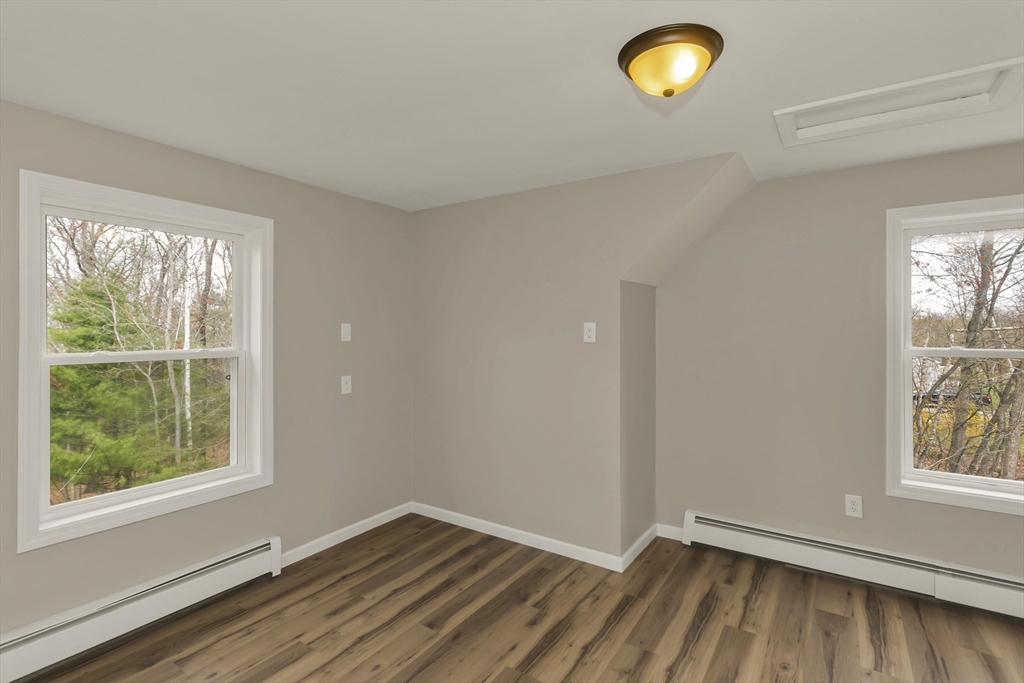 374 Rondeau Street Palmer, MA 01069 - Photo 21 of 27 an empty room with wooden floor and windows