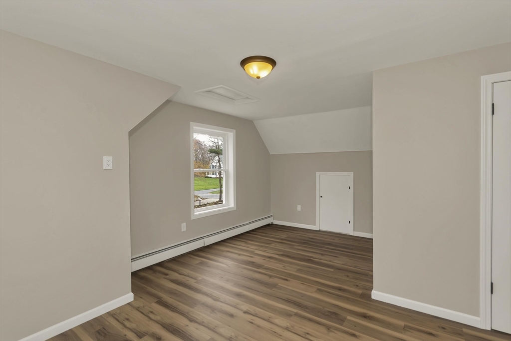 374 Rondeau Street Palmer, MA 01069 - Photo 22 of 27 a view of an empty room with window and wooden floor