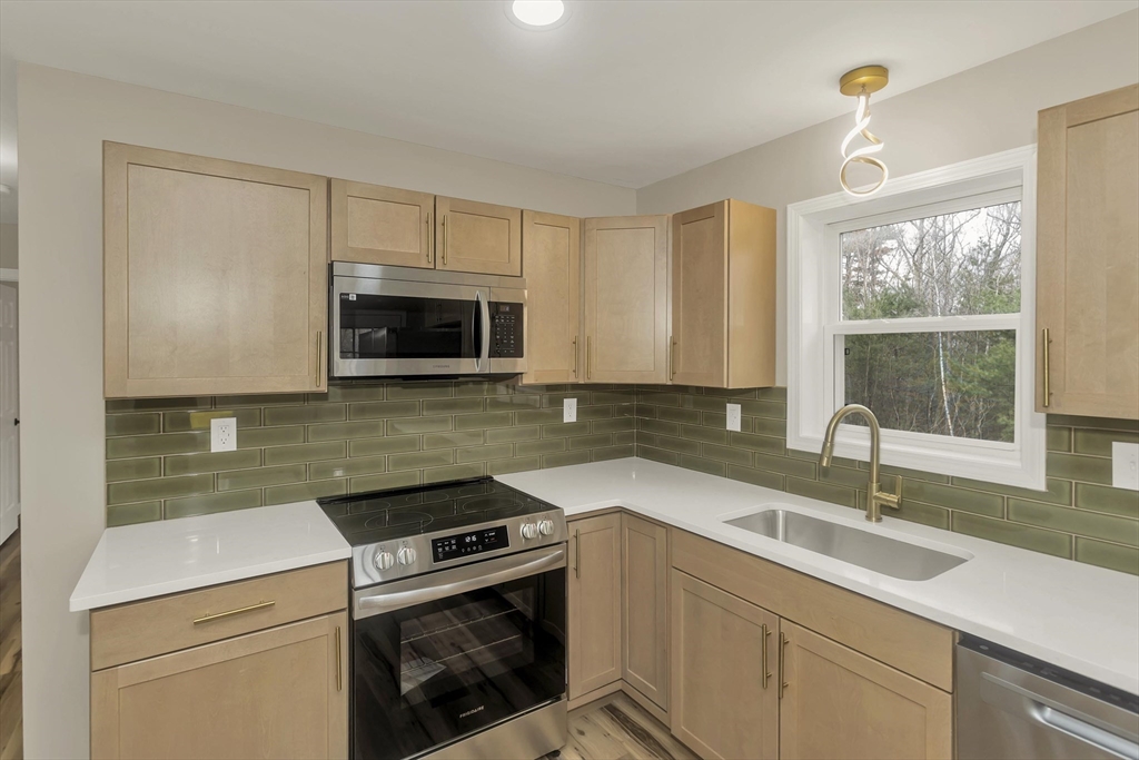 374 Rondeau Street Palmer, MA 01069 - Photo 3 of 27 a kitchen with a sink stove and microwave