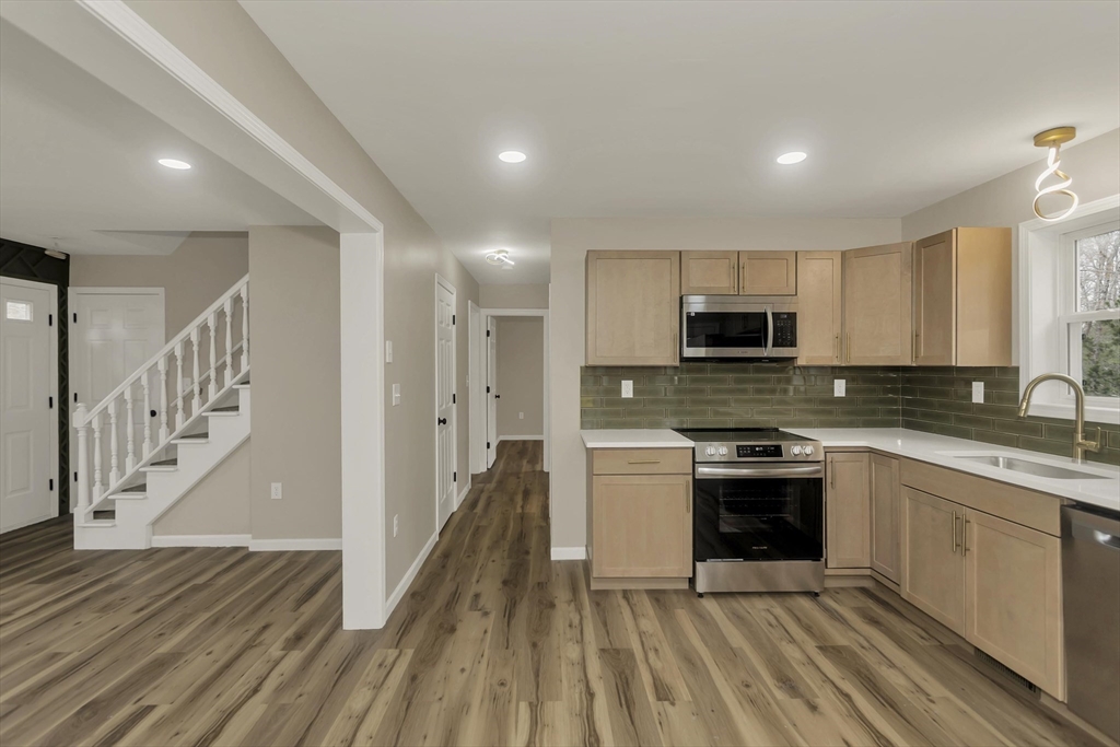 374 Rondeau Street Palmer, MA 01069 - Photo 4 of 27 a large kitchen with stainless steel appliances granite countertop a stove a sink and a refrigerator