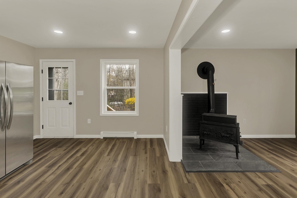 374 Rondeau Street Palmer, MA 01069 - Photo 6 of 27 a view of a livingroom with wooden floor and a ceiling fan