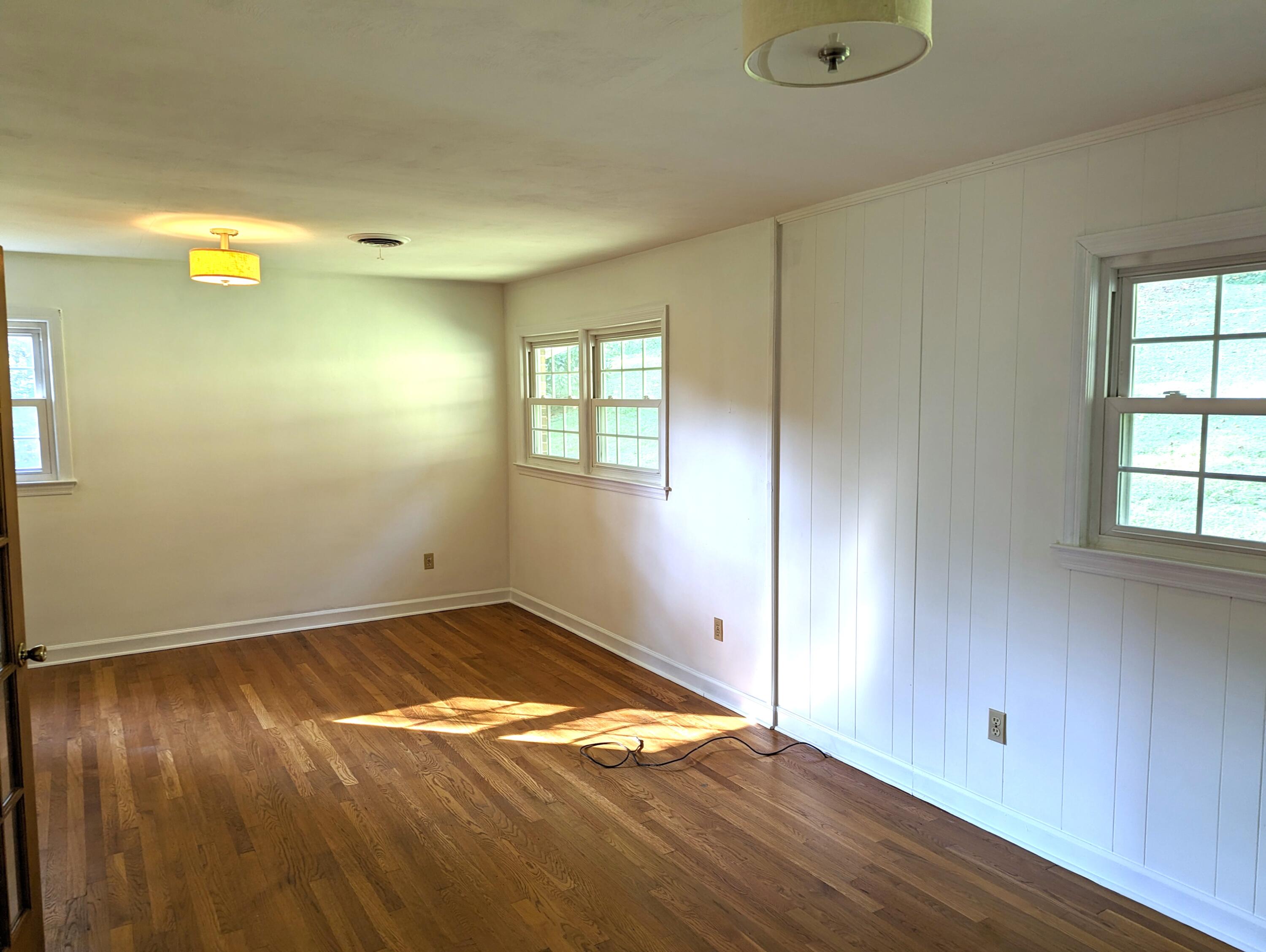 1769 Factory Hill Road Callaway, VA 24067 - Photo 12 of 53 an empty room with wooden floor and windows