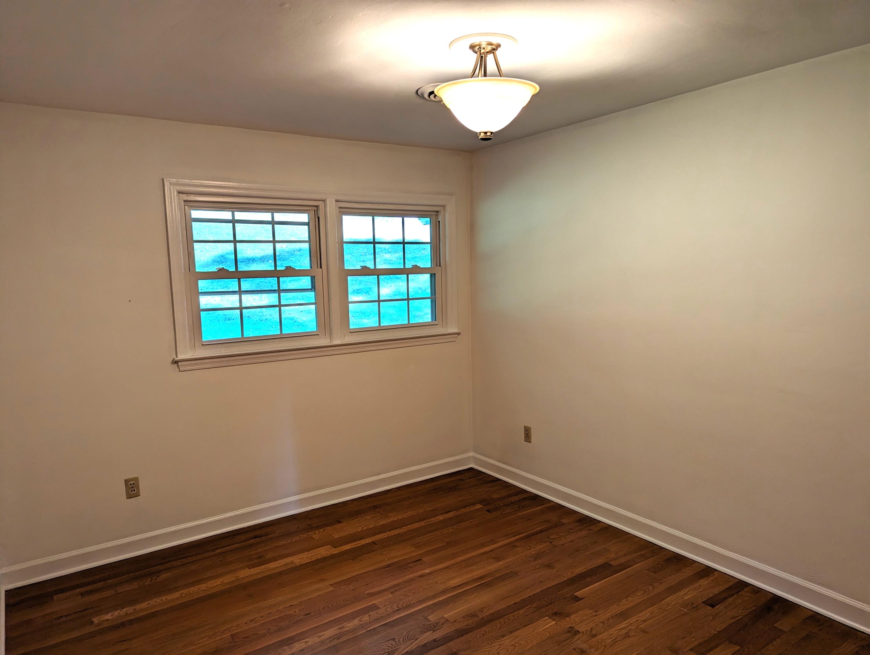1769 Factory Hill Road Callaway, VA 24067 - Photo 18 of 53 a view of an empty room with wooden floor and a window
