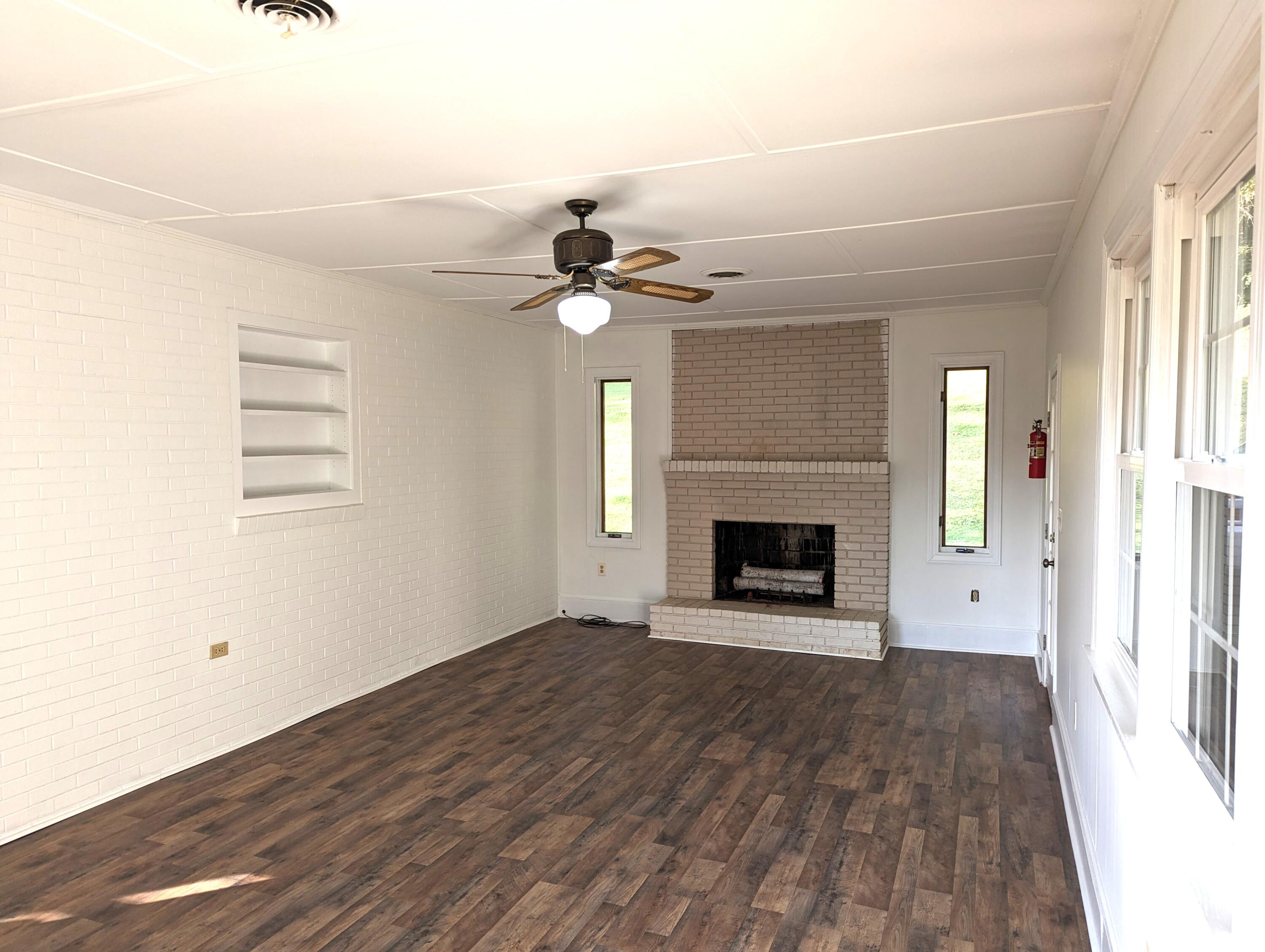 1769 Factory Hill Road Callaway, VA 24067 - Photo 28 of 53 an empty room with windows and a fireplace