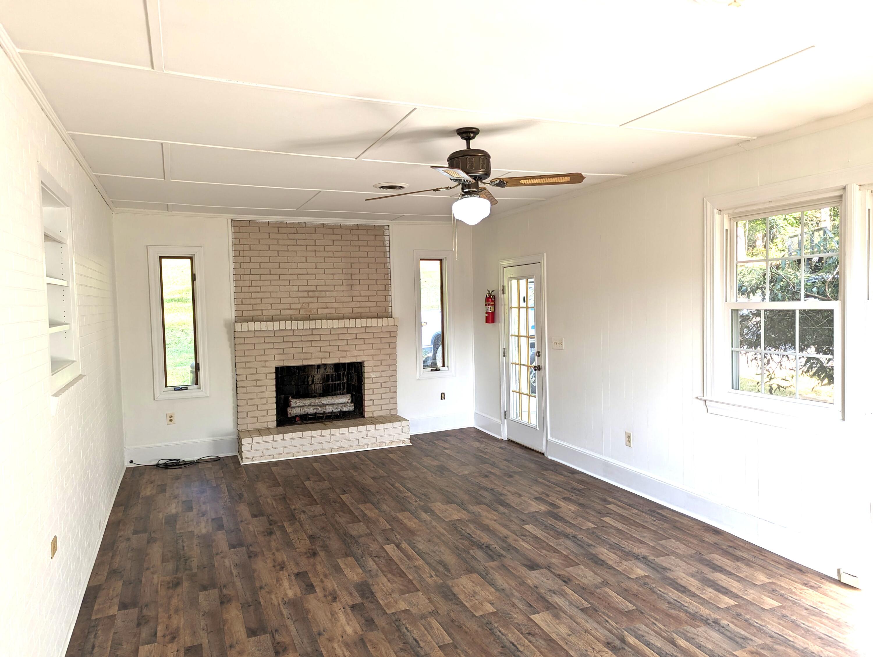 1769 Factory Hill Road Callaway, VA 24067 - Photo 3 of 53 an empty room with windows and a fireplace