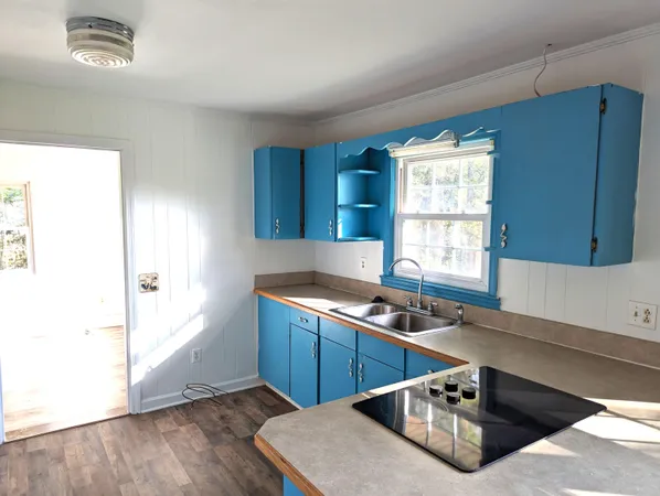 a kitchen with stainless steel appliances granite countertop a sink a stove and a refrigerator