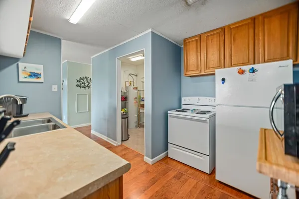 a bedroom with bed and a refrigerator