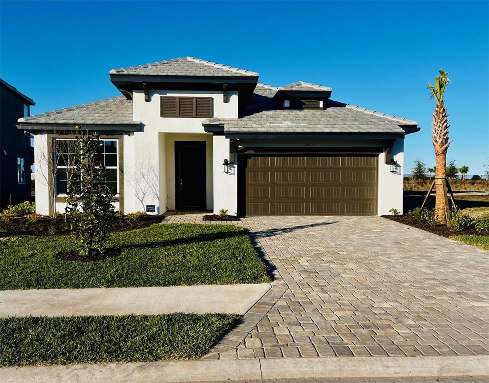 17502 Savory Mist Circle Lakewood Ranch, FL 34211 - Photo 1 of 1 a front view of a house with a yard
