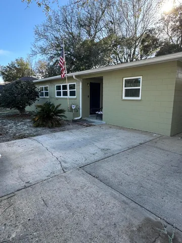 a front view of a house with a garden