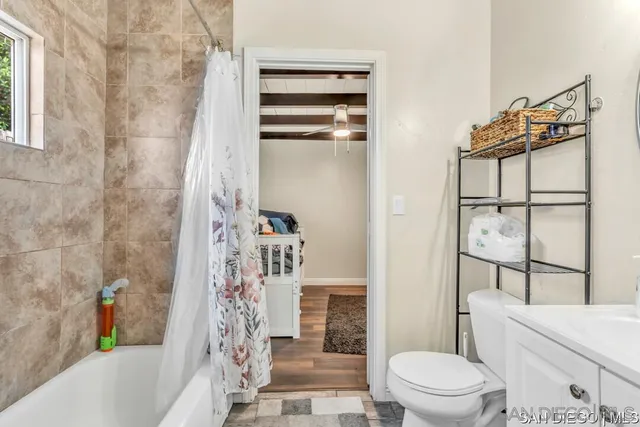 a bathroom with a toilet and a shower