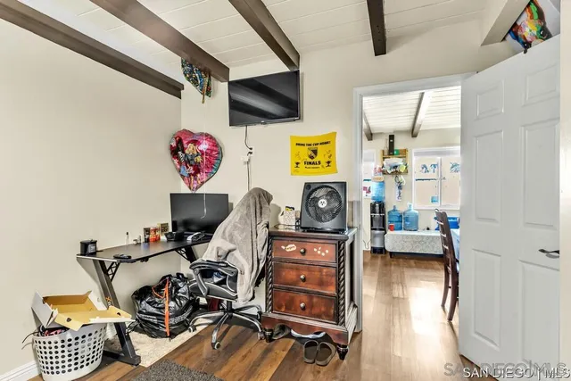 a view of a workspace with furniture and a window