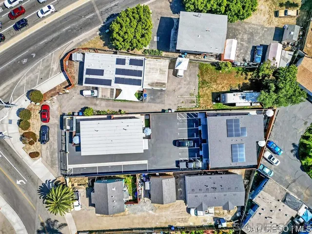 an aerial view of residential houses with outdoor space