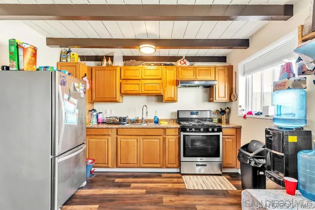 a kitchen with stainless steel appliances a stove and a refrigerator