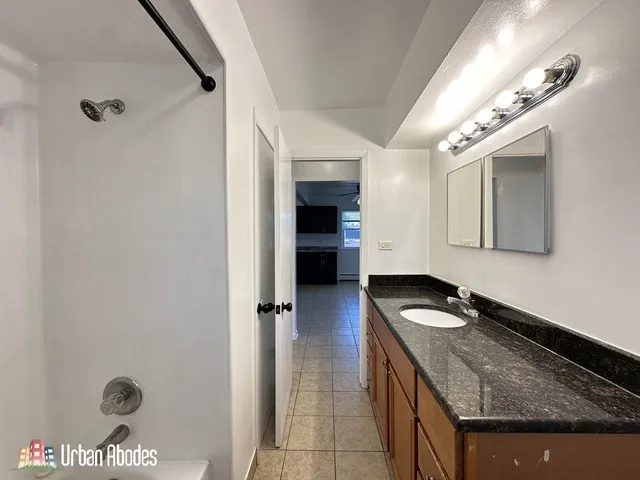 a kitchen that has a sink a stove and cabinets
