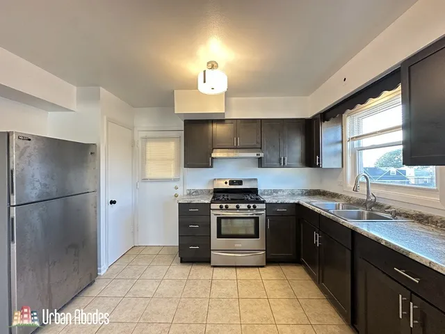 a kitchen with a sink stainless steel appliances and cabinets