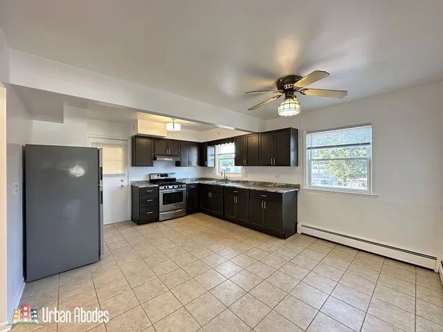 a large kitchen with a stove a sink and a refrigerator