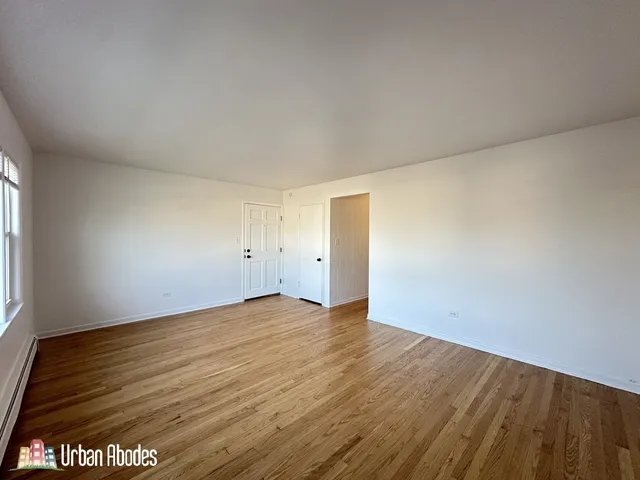 an empty room with wooden floor