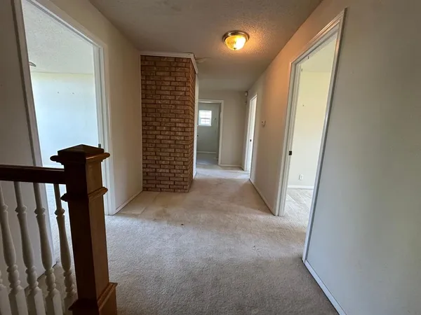 a view of an empty room with a fireplace