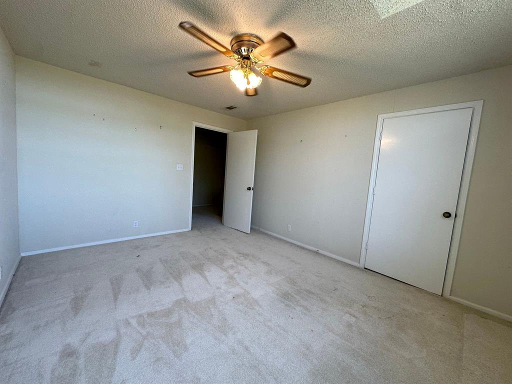 11552 Massey Road Pilot Point, TX 76258 - Photo 20 of 38 an empty room with chandelier fan and windows