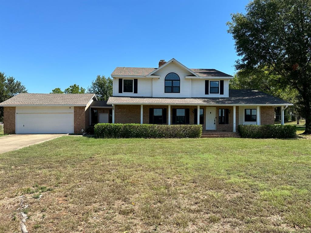 11552 Massey Road Pilot Point, TX 76258 - Photo 2 of 38 a front view of a house with a garden