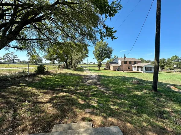 a view of a park with large trees