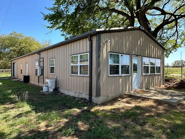 a house with trees in the background