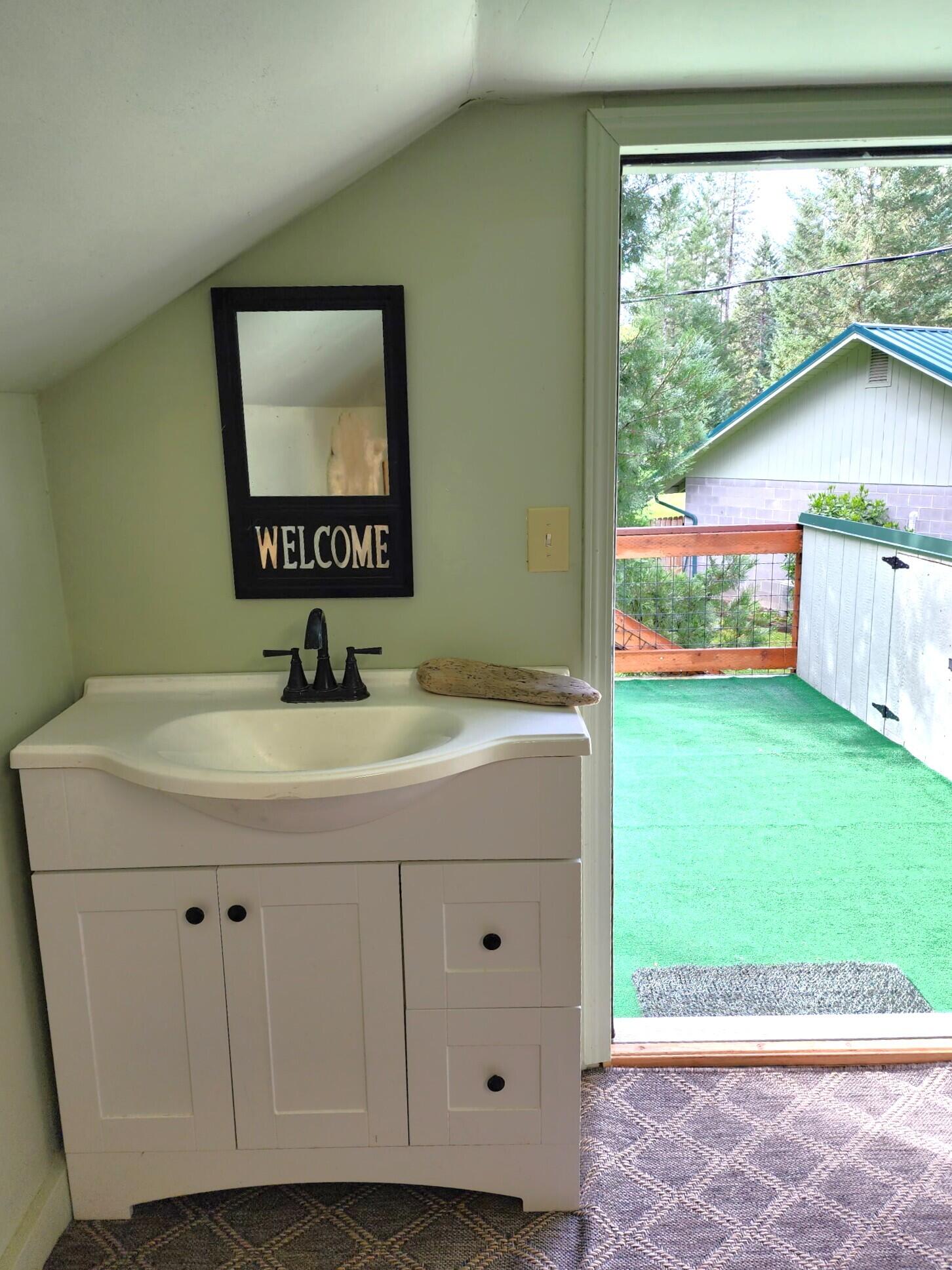 244 Riessen Road Grants Pass, OR 97526 - Photo 43 of 52 a bathroom with a sink mirror and a window