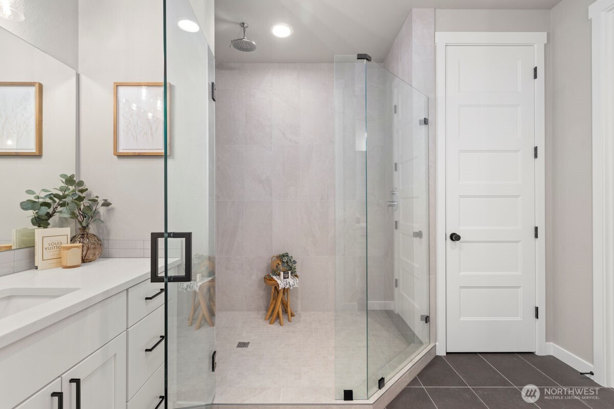7879 South 132nd Street Seattle, WA 98178 - Photo 23 of 37 a bathroom with a tub shower vanity and a sink